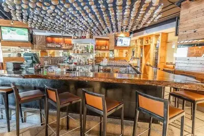 a bar in a restaurant with chairs around it at Mammoth Monache Resort in Mammoth Lakes
