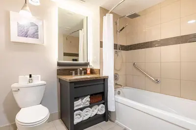 a bathroom with a toilet and a sink and a tub at Mammoth Monache Resort in Mammoth Lakes