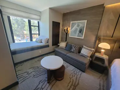 a living room with a couch and a bed at Mammoth Monache Resort in Mammoth Lakes