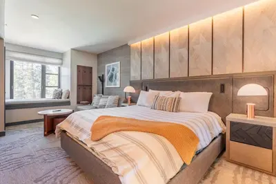 a bedroom with a large bed and a television at Mammoth Monache Resort in Mammoth Lakes