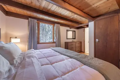 a bedroom with a large bed and a window at Dollar Point - Observation Dr, home in Tahoe City