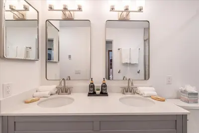two sinks in a bathroom with two mirrors at Dollar Point - Observation Dr, home in Tahoe City