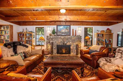 a living room with leather furniture and a fireplace at Nightingale's Nest in Carnelian Bay