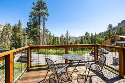 a patio with a table and chairs on a deck at Alpine Meadows Basecamp in Alpine Meadows