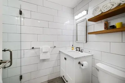 a white bathroom with a sink and a toilet at Alpine Meadows Basecamp in Alpine Meadows