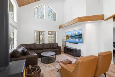 a living room with a couch and a table at Shaver Escape Hot Tub Cabin Retreat with AC in Shaver Lake