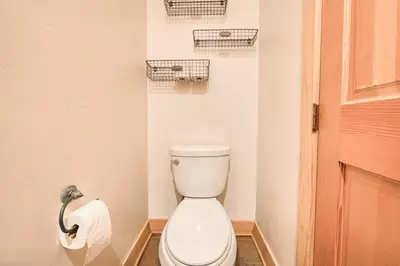 a bathroom with a toilet and a toilet paper dispenser at Easy Living at Northstar by Tahoe Getaways - 4BR Pet Friendly w/ Ski Shuttle & HOA in Truckee