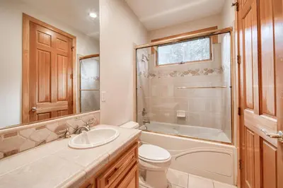 a bathroom with a sink and a toilet and a shower at Easy Living at Northstar by Tahoe Getaways - 4BR Pet Friendly w/ Ski Shuttle & HOA in Truckee