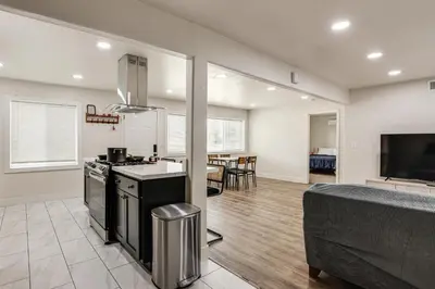 a kitchen and living room with a stove and a couch at Under 1 Mi to Med Center! Stylish Home in Tulare in Tulare