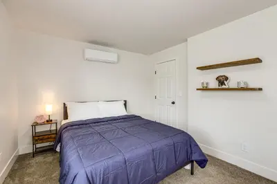 a bedroom with a bed with a purple blanket at Under 1 Mi to Med Center! Stylish Home in Tulare in Tulare