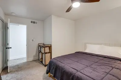 a bedroom with a bed and a ceiling fan at Under 1 Mi to Med Center! Stylish Home in Tulare in Tulare