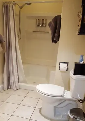 a bathroom with a white toilet and a shower at Nature's Inn Bed and Breakfast in Ahwahnee