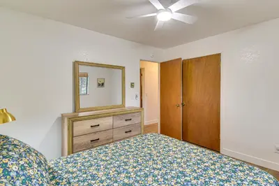 a bedroom with a bed and a dresser and a mirror at Less Than 1 Mi to Twain Harte Lake Forest-View Retreat! in Twain Harte