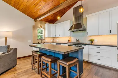 a kitchen with a large blue island with stools at Little Bridge Lodge Stateline - Small Dogs Ok in Stateline