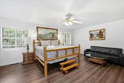 a bedroom with a bed and a couch at Fun Getaway with Golf HotTub Volleyball and more in Oakhurst