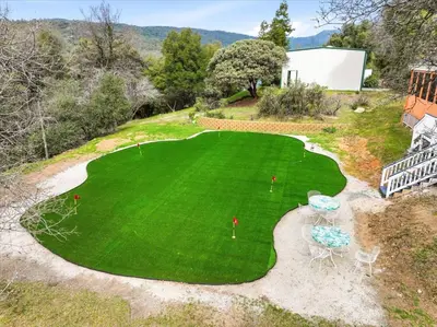 an overhead view of a green lawn with tables and chairs at Fun Getaway with Golf HotTub Volleyball and more in Oakhurst