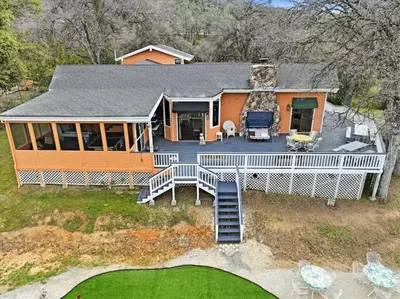 an aerial view of a house with a large deck at Fun Getaway with Golf HotTub Volleyball and more in Oakhurst