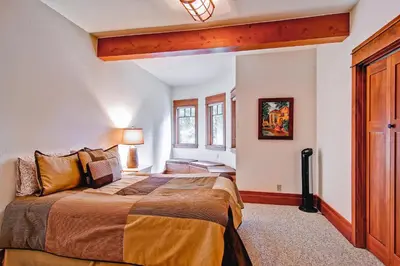 a bedroom with a large bed and a window at Ahwahnichi Lodge in Yosemite West