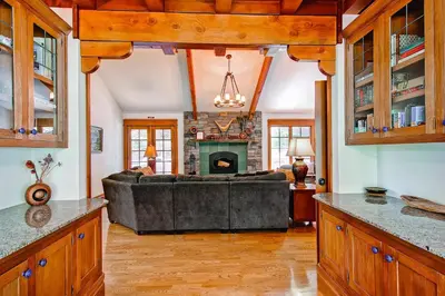 a living room with a couch and a fireplace at Ahwahnichi Lodge in Yosemite West