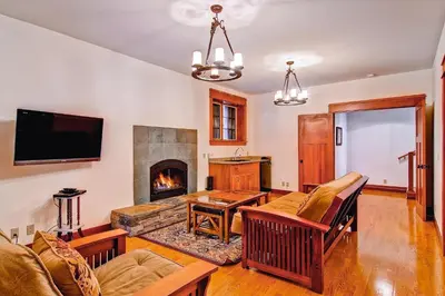 a living room with a couch and a fireplace at Ahwahnichi Lodge in Yosemite West