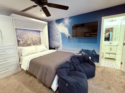 a bedroom with a large bed and a painting on the wall at Luxury Helios Retreat by the Village- Apres Ready in Mammoth Lakes