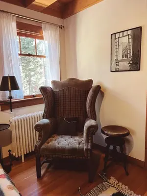a living room with a chair and a window at Campo Carnelian in Carnelian Bay