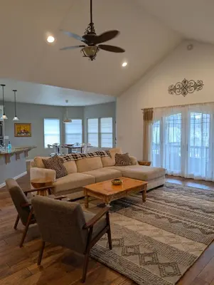 a living room with a couch and a table at Quiet Murphys getaway steps away from 25+ wineries in Murphys