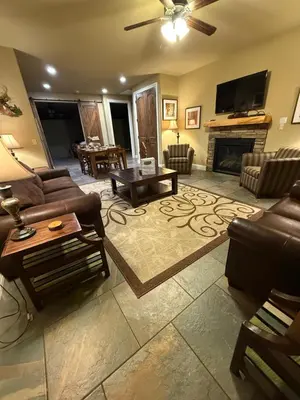 a living room with a couch and a fireplace at Yosemite's Inn the Woods in Ahwahnee