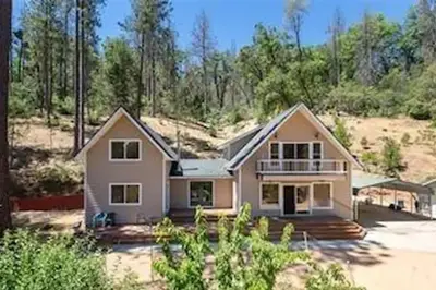 a house in the middle of a field at Stay at Whispering Pines, only 25 mi to Yosemite! in Midpines
