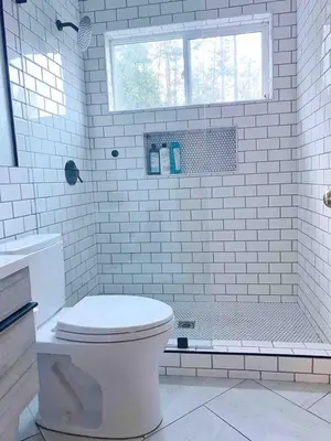 a white bathroom with a toilet and a shower at Stay at Whispering Pines, only 25 mi to Yosemite! in Midpines