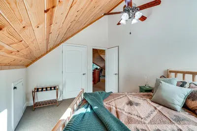 a bedroom with a bed with a wooden ceiling at Game Room and Hot Tub! Dog-Friendly Arnold Retreat in Arnold