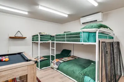 two bunk beds in a room with a pool table at Game Room and Hot Tub! Dog-Friendly Arnold Retreat in Arnold