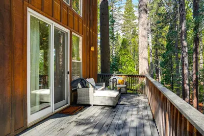 a deck with a couch and chairs on a house at Game Room and Hot Tub! Dog-Friendly Arnold Retreat in Arnold
