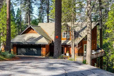 a house in the woods with a driveway at Game Room and Hot Tub! Dog-Friendly Arnold Retreat in Arnold
