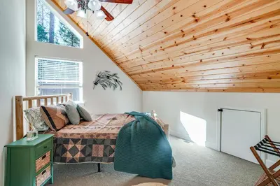 a bedroom with a bed and a wooden ceiling at Game Room and Hot Tub! Dog-Friendly Arnold Retreat in Arnold