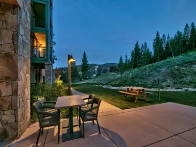 a patio with a table and chairs next to a building at Northstar Ritz-Carlton in Truckee