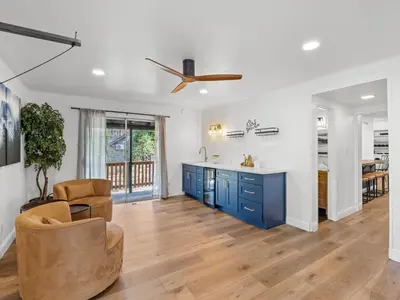 a kitchen with blue cabinets and a ceiling fan at Forest Retreat that accommodates 29 people near Yosemite & Bass Lake in Oakhurst