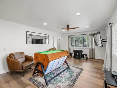 a living room with a pool table and a couch at Forest Retreat that accommodates 29 people near Yosemite & Bass Lake in Oakhurst