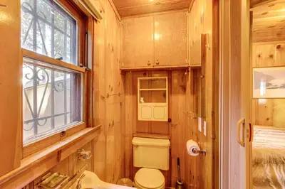 a bathroom with a toilet and a sink and a window at Close to Lake and Heavenly Mtn Resort! Quaint Cabin in South Lake Tahoe