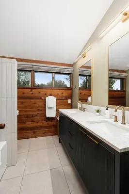 a bathroom with two sinks and a large mirror at New! Stunning views Hot tub King beds in Oakhurst
