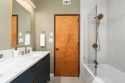 a bathroom with a tub and a sink and a shower at New! Stunning views Hot tub King beds in Oakhurst