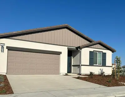 a white house with a garage at Prime Location Residence in Manteca