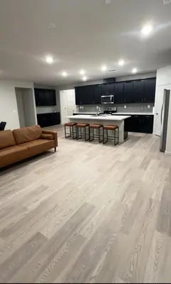 a large living room with a couch and a kitchen at Prime Location Residence in Manteca