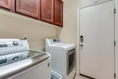a small kitchen with a washer and dryer at Sophisticated Sanctuary 8 Mi to Lodi Wineries! in Stockton
