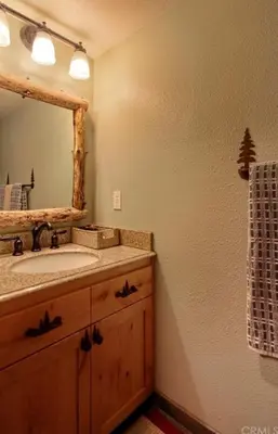 a bathroom with a sink and a mirror at Vista Chalet near Yosemite and Bass Lake in Oakhurst