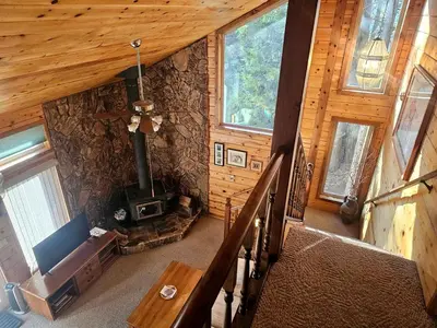 an overhead view of a log cabin with a wood stove at Peaceful Mountain Cabin with Private Lake and Game Room Near Long Barn, California in Long Barn
