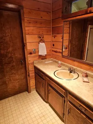 a bathroom with a sink and a mirror at Peaceful Mountain Cabin with Private Lake and Game Room Near Long Barn, California in Long Barn