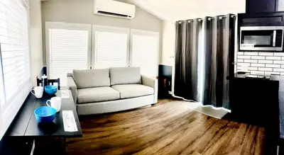 a living room with a couch and a table at Modern Tiny Home with Mountain Views Near Mt. Whitney, Lone Pine, California in Lone Pine