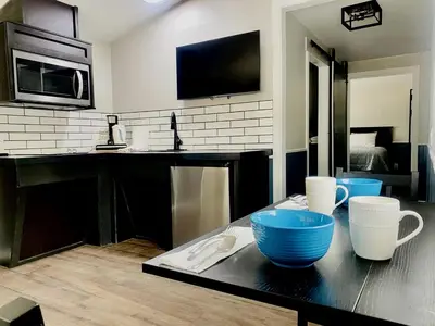 a kitchen with blue bowls on a table at Modern Tiny Home with Mountain Views Near Mt. Whitney, Lone Pine, California in Lone Pine
