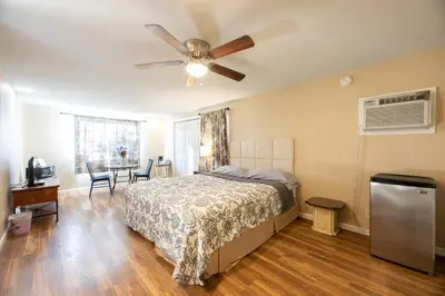 a bedroom with a bed and a ceiling fan at St Annas House in Squaw Valley